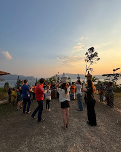 
              Rwandan Women dancing outside wearing traditional clothing